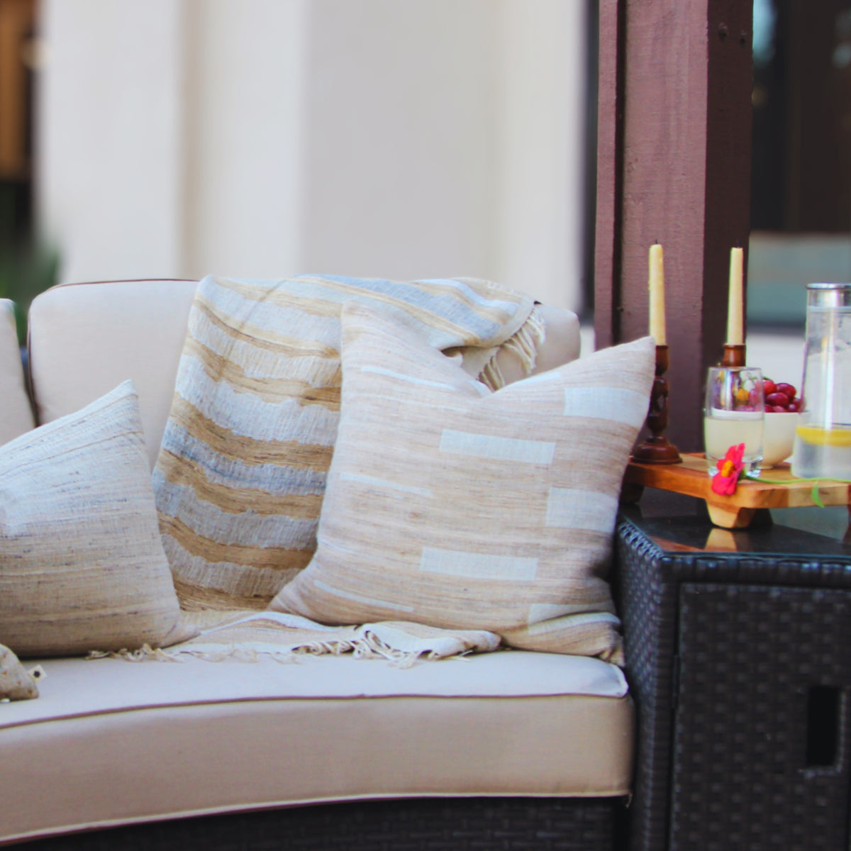 Close-up of the Montecito cushion weave: ivory blocks on streaked taupe and sand