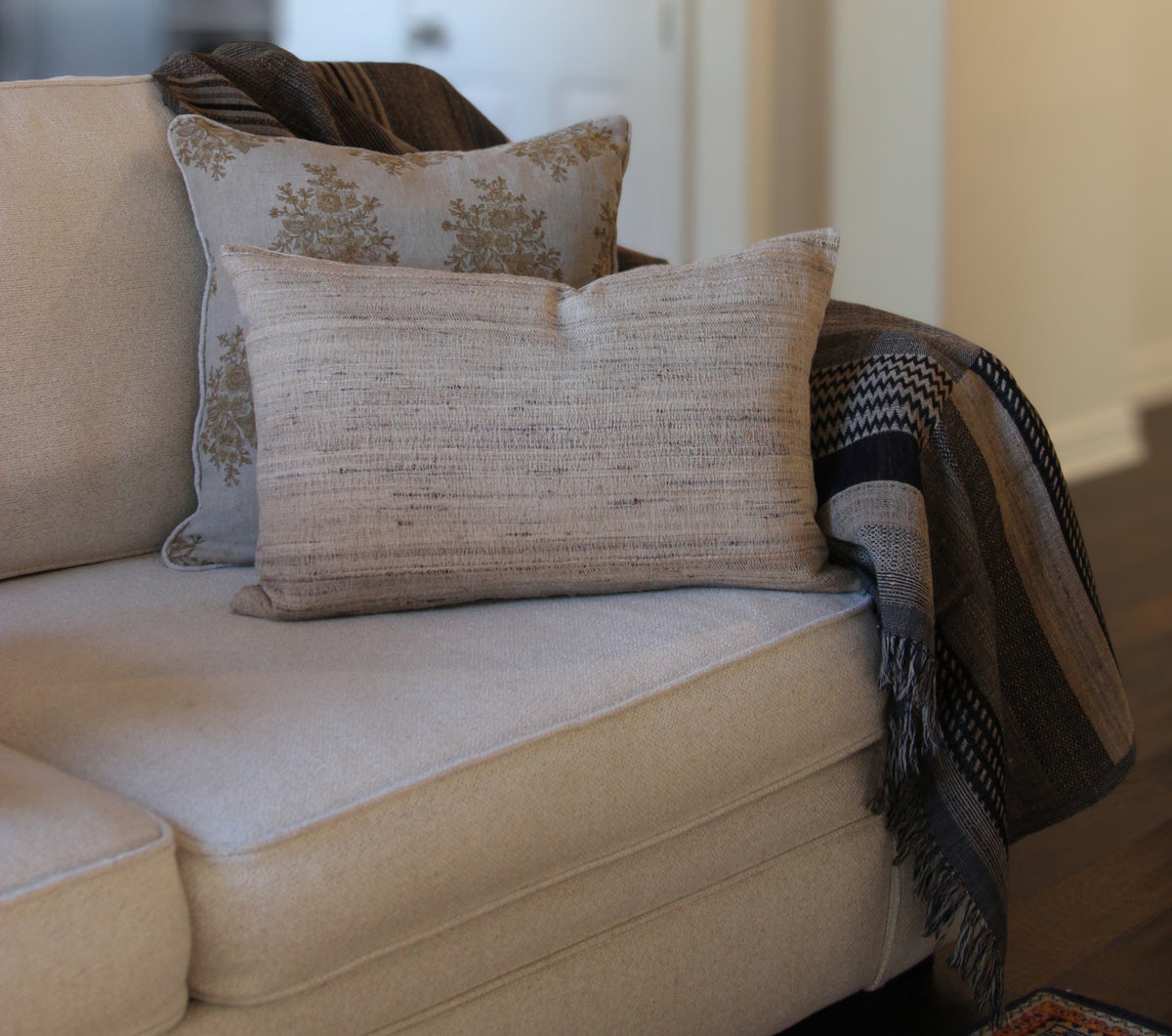 Diwan Coronado wool and silk lumbar cushion on a sofa