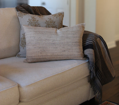 Diwan Coronado wool and silk lumbar cushion on a sofa