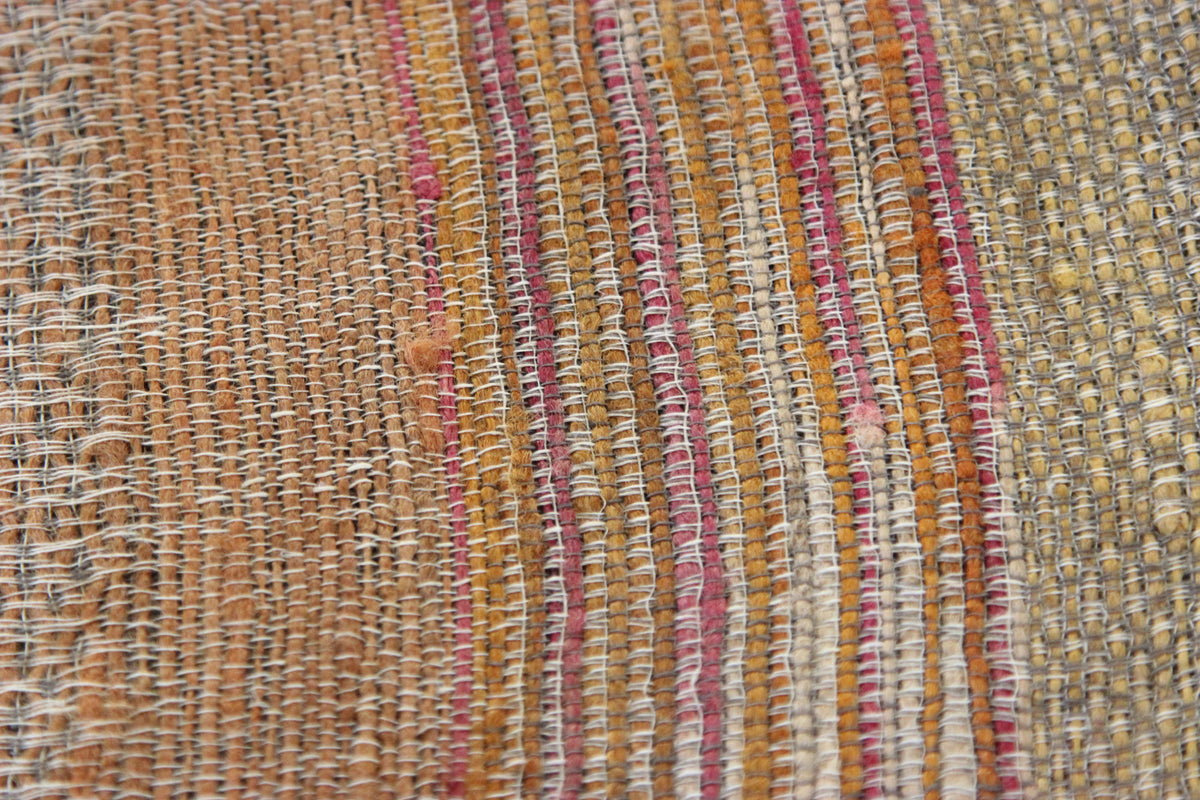 Close-up of the Diwan linen and silk throw in Ojai: tan, mustard, cream and pink stripes