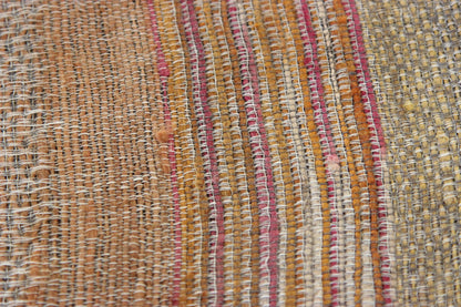 Close-up of the Diwan linen and silk throw in Ojai: tan, mustard, cream and pink stripes