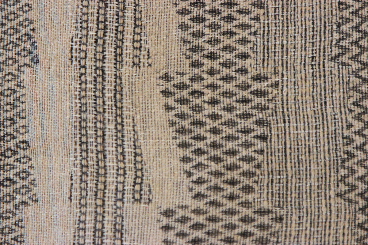 Close-up of the Diwan linen and silk throw in Half Moon Bay: charcoal geometric pattern on beige