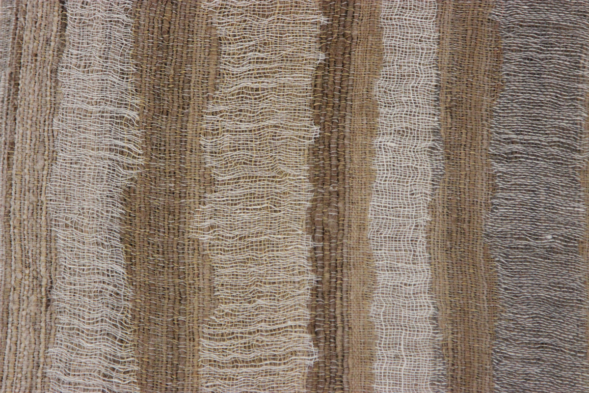 Close-up of the Diwan linen and silk throw in Montecito: beige, taupe, brown and grey bands