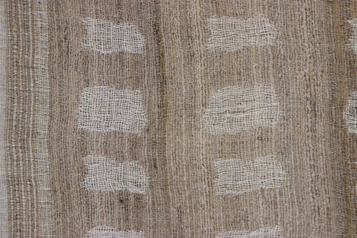 Close-up of the Diwan linen and silk throw in Laguna: tan and brown with white woven bands