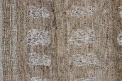 Close-up of the Diwan linen and silk throw in Laguna: tan and brown with white woven bands