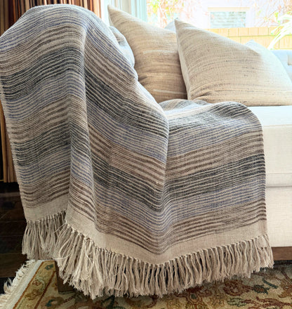 Diwan handwoven linen throw in Del Mar, blue and natural, draped on a diwan