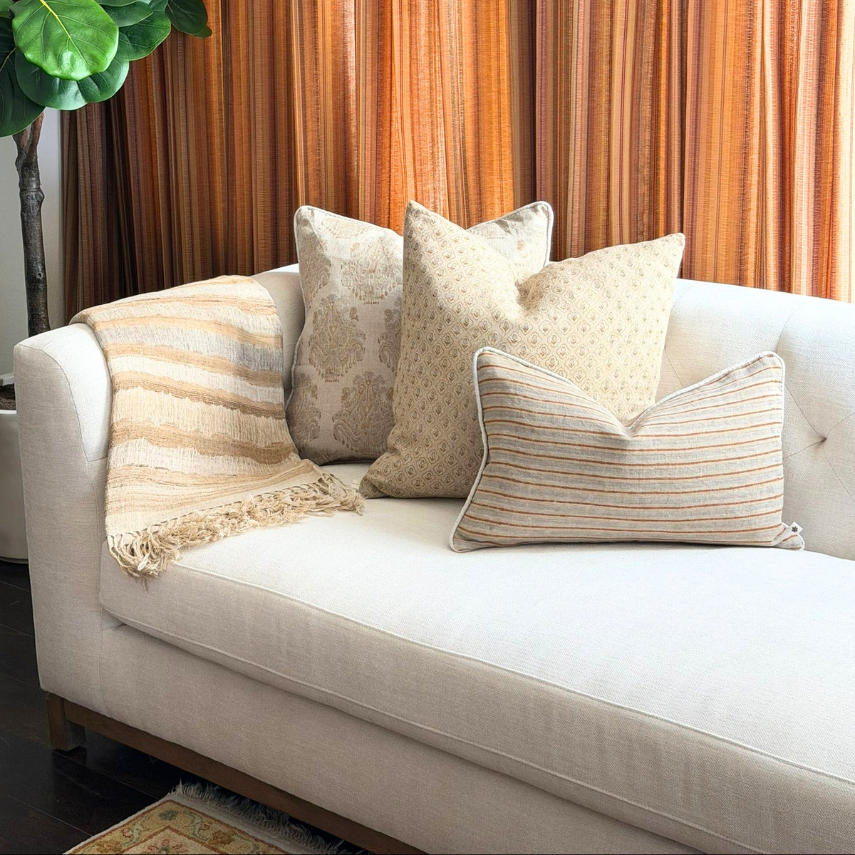 Diwan linen and silk throw in Montecito on a cream sofa with neutral cushions
