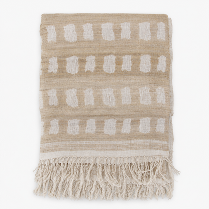 Folded handwoven linen and silk throw with fringe in a beige and off-white block pattern
