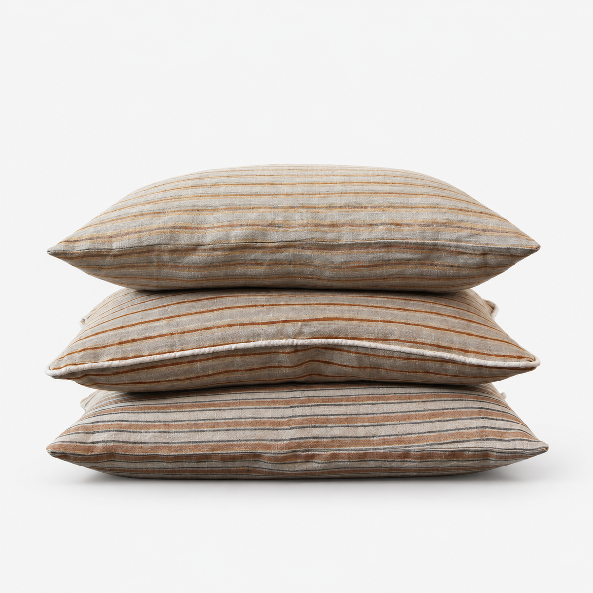 Three Diwan hand block printed linen lumbar covers stacked: Ojai, Del Mar and Montecito stripes