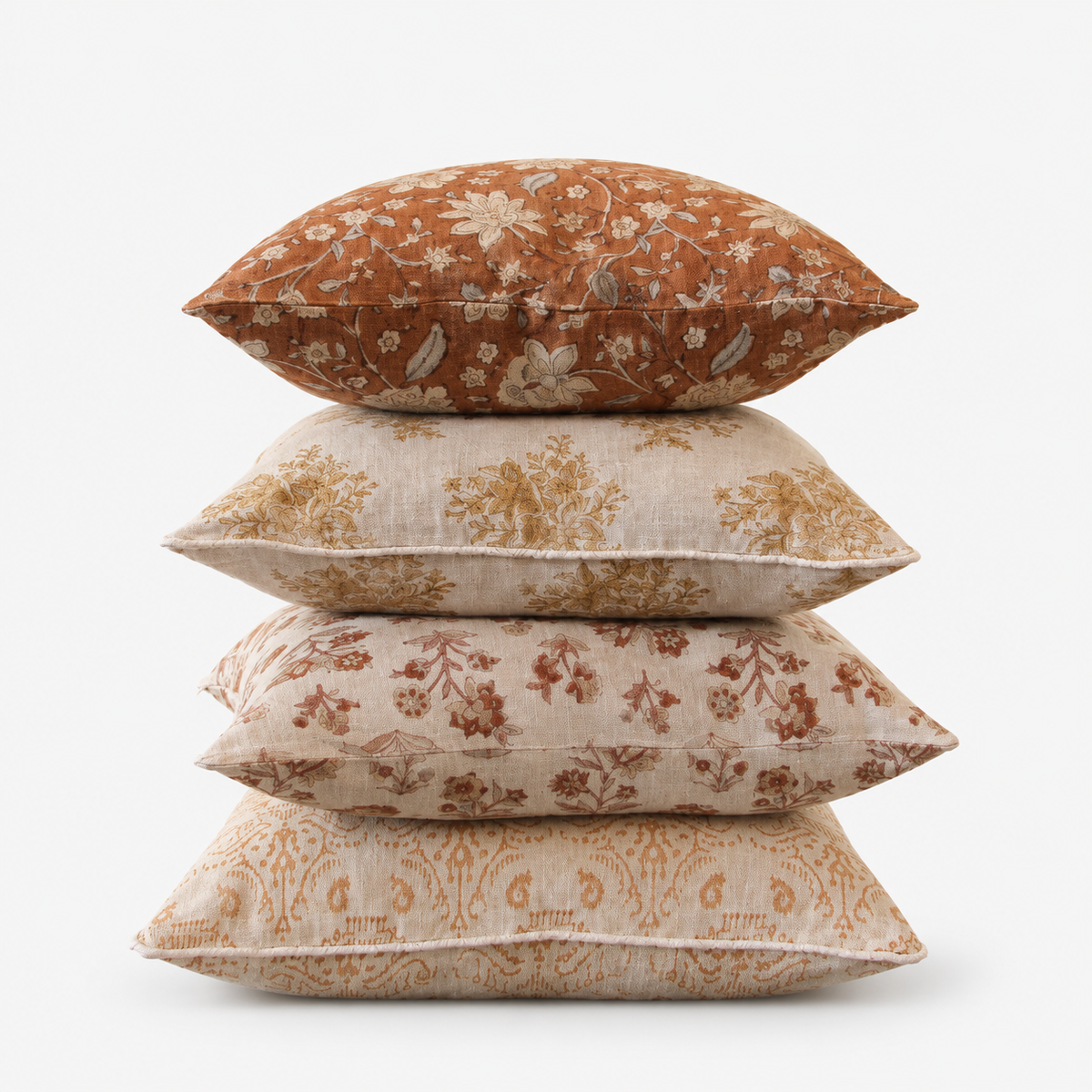 Stack of Diwan hand block printed linen cushion covers in floral and paisley designs