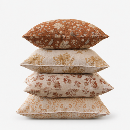 Stack of Diwan hand block printed linen cushion covers in floral and paisley designs