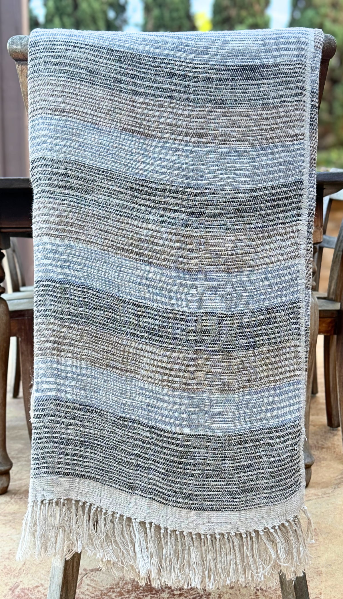 Diwan handwoven linen throw in Del Mar draped over a chair